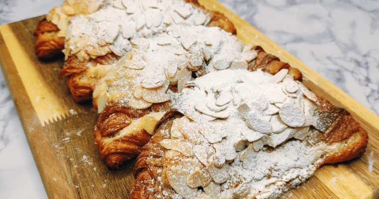 croissants filled with almond cream, topped with almond flakes, and dusted with icing sugar