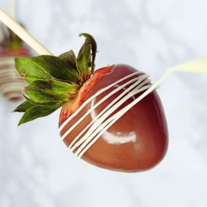 chocolate covered strawberry with white chocolate drizzle