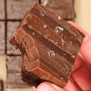 chocolate ganache brownies topped with salt flakes, with a bite