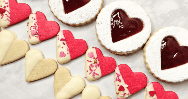 heart sugar cookies, some filled with jam, others dipped in chocolate