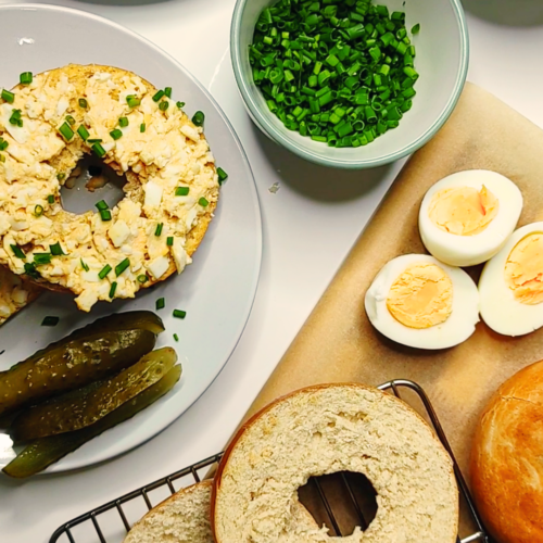 bagel topped with an egg sandwich filling