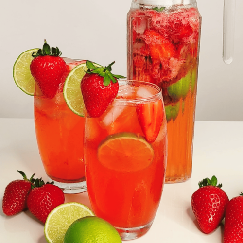 strawberry lime mocktail in a pitcher and glass